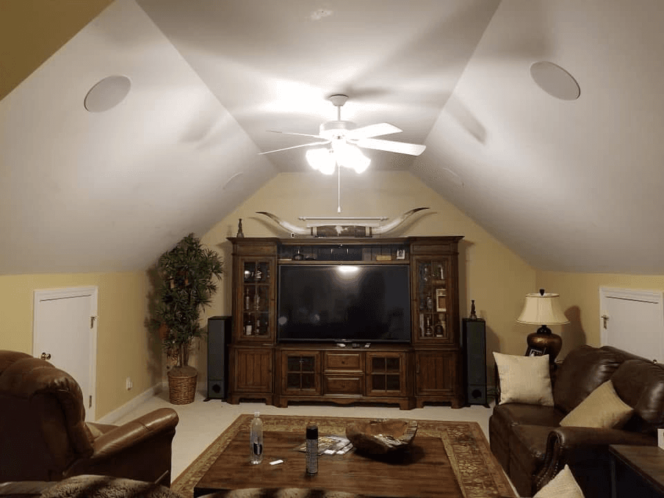 Bonus room home theater with entertainment center, tower speakers, and in-ceiling surround sound