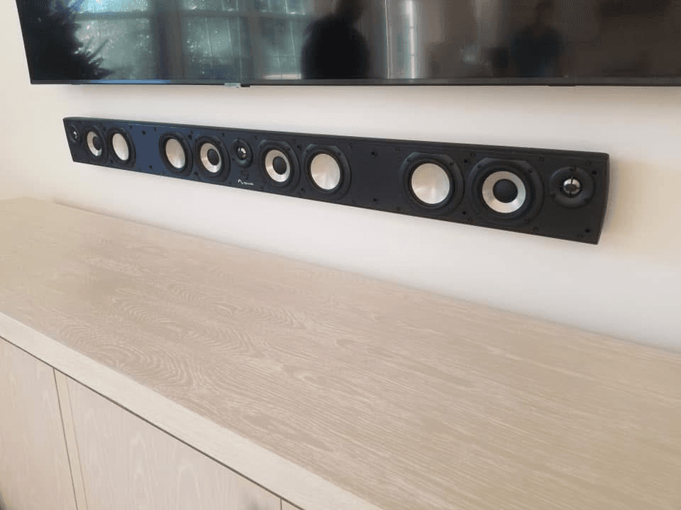 Slim multi-driver soundbar mounted on entertainment credenza