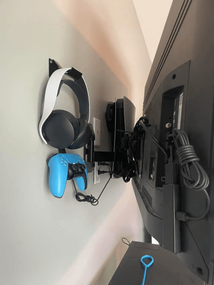 Side view of full-motion mount with PS VR headset and controller wall hooks