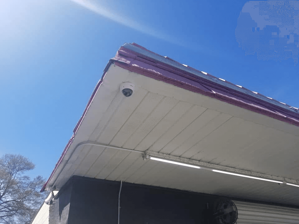 Dome security camera mounted on commercial building soffit
