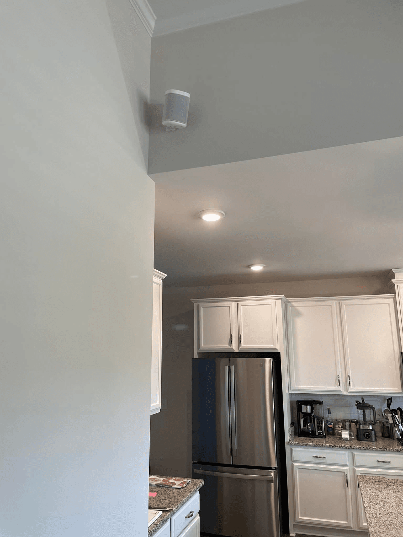 Sonos Era ceiling-mounted speaker in kitchen above cabinets